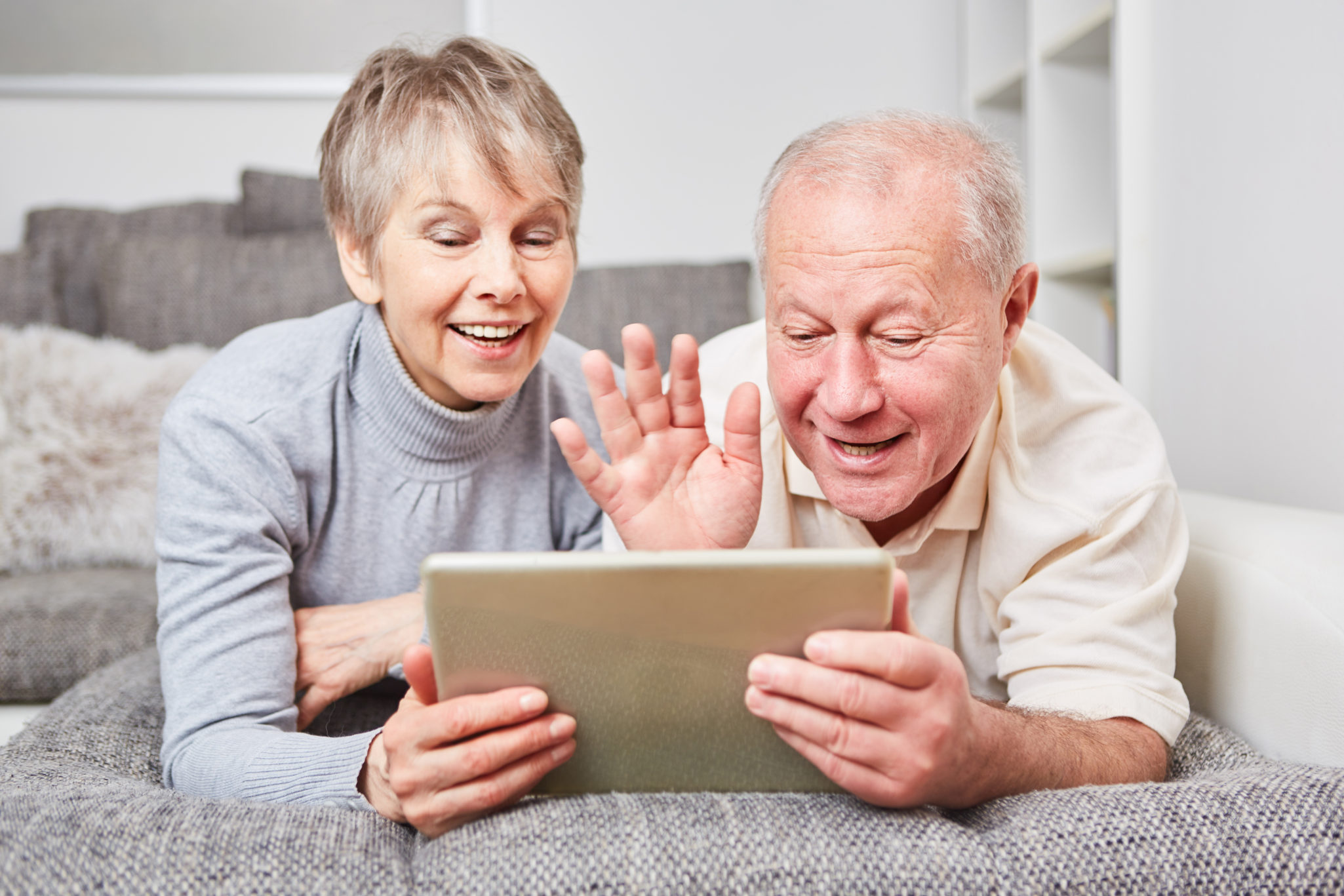 senior couple using laptop for facetime or zoom