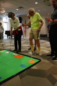 Seniors playing Mini Golf at Lakewood Senior Living