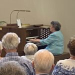 Senior woman playing the Organ at the Spiritual Music Event